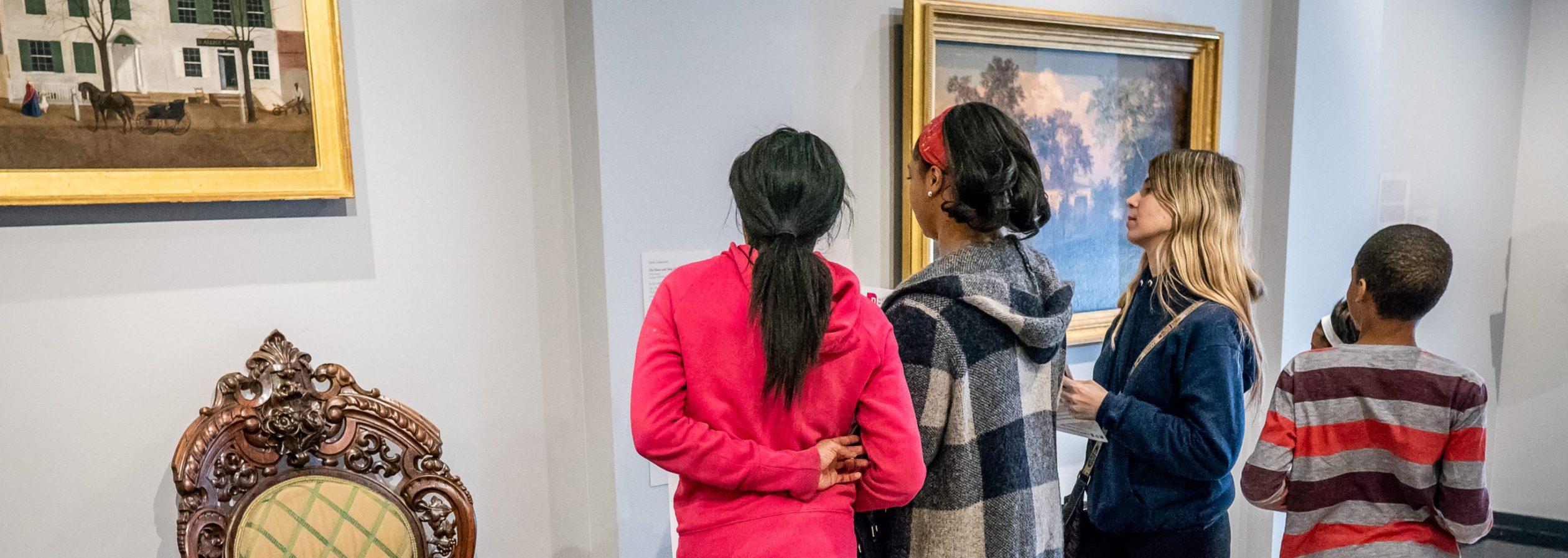 small group of young people looking at art
