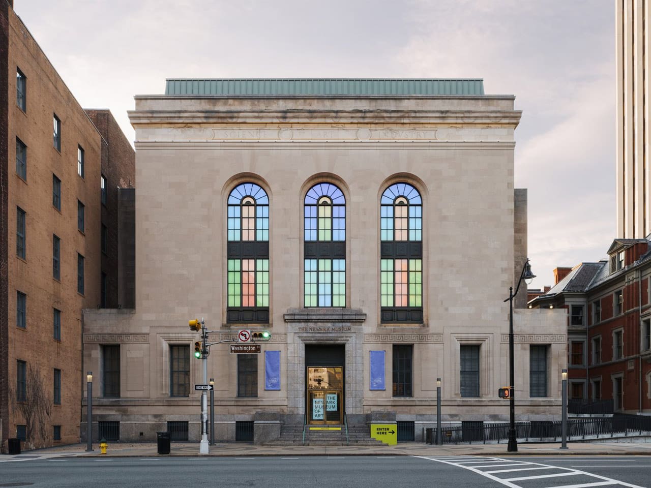 Phillip K. Smith III’s Three Half Lozenges, 2017-2021 Existing historic windows, alupoly, aluminum, LED lighting, electronic components, unique color choreography. Photo by Lance Gerber. Newark Museum of Art. Daytime.