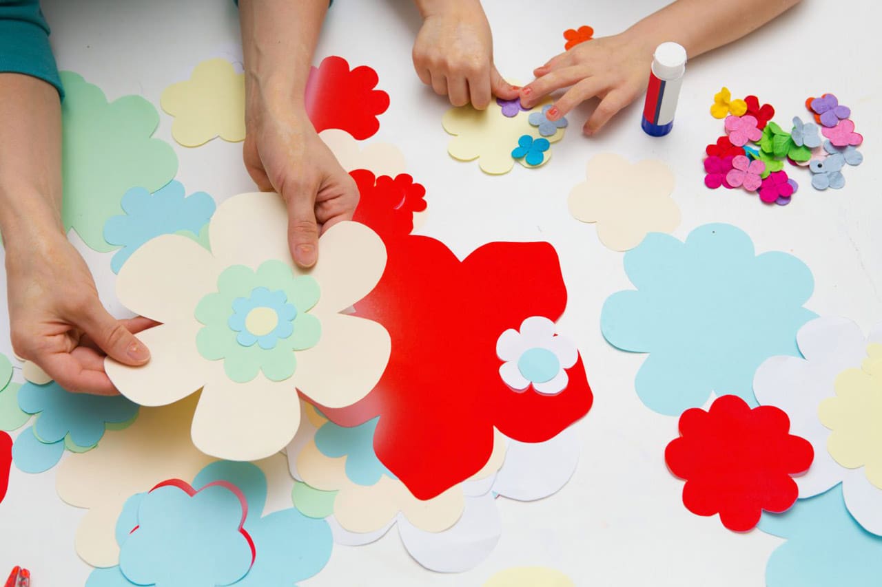 mother and the child prepare together Paper decor. children's creativity. Tools and materials for children's art creativity on table.