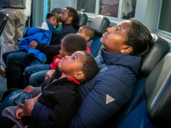 Parent and child watching planetarium show Newark Museum of Art