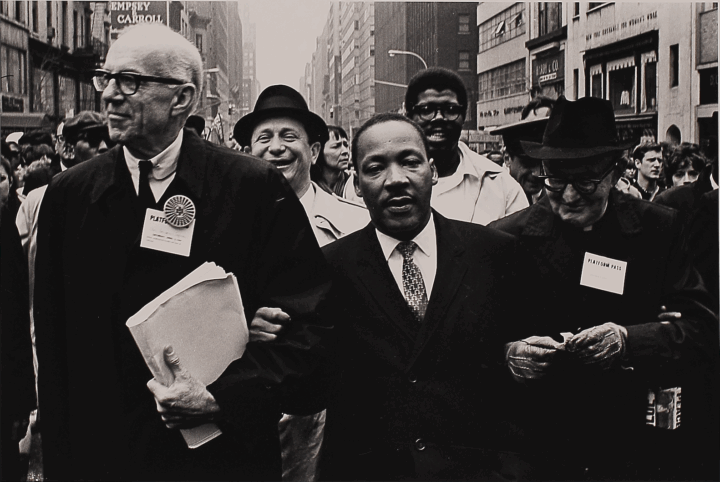 MLK standing in center of group