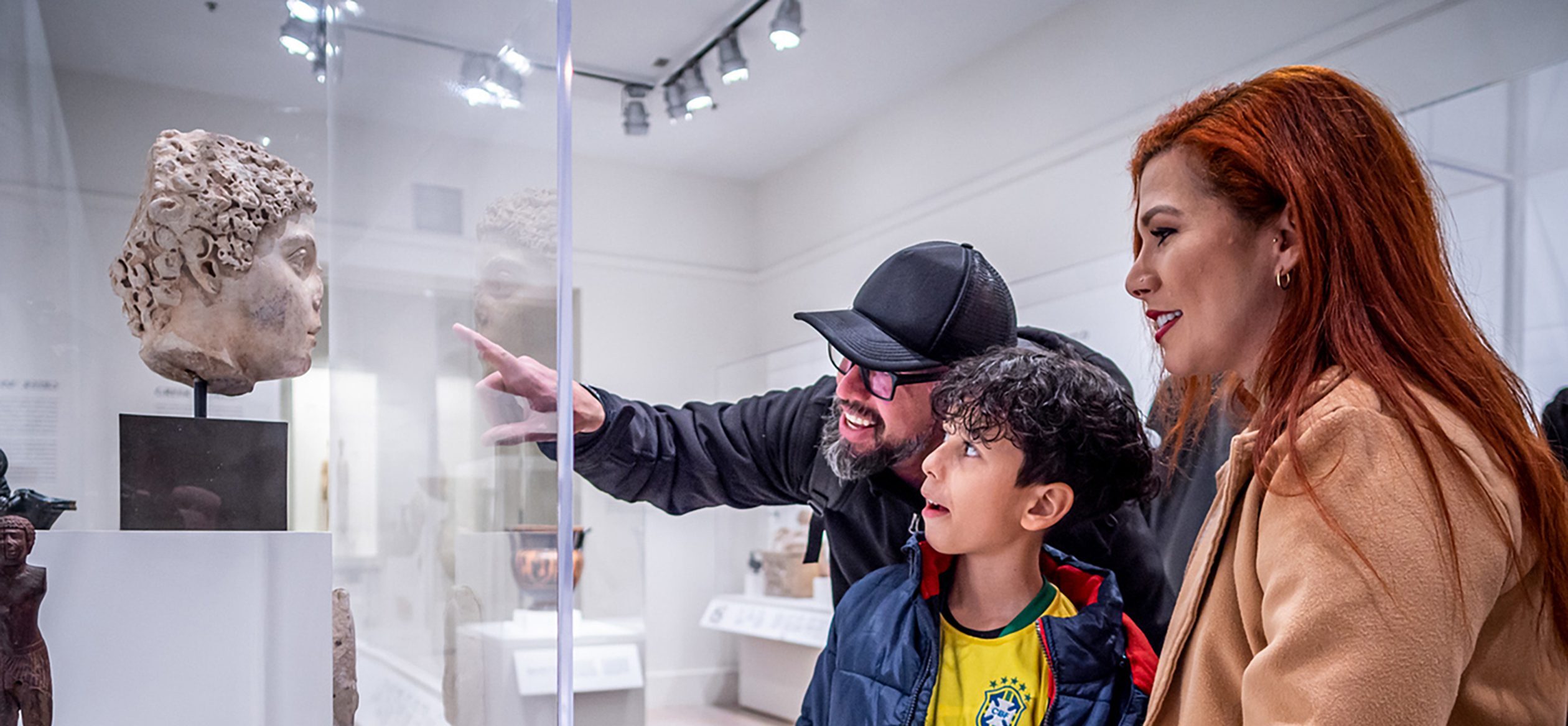 People in the museum looking at object